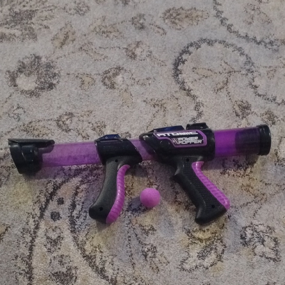 Purple and Black Toy Blaster by NERF